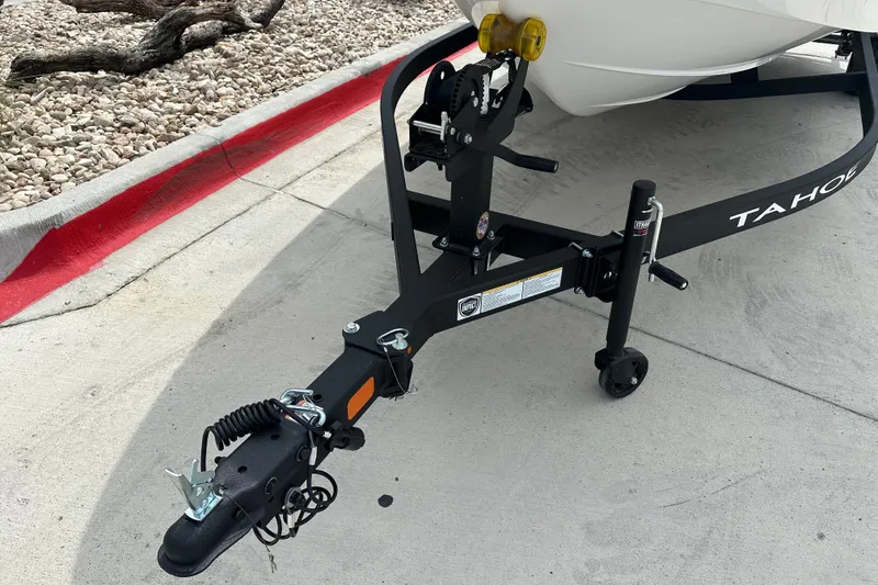 Slide: The Image of Trailer hitch of a 2027 Tahoe T18 boat on a concrete surface. - 23