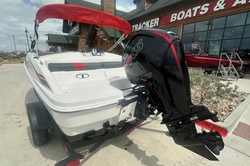 Slide: The Image of 2027 Tahoe T18 boat with outboard motor, displayed at a dealership. - 10
