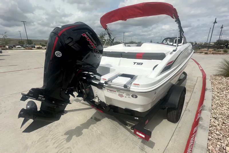 Slide: The Image of 2027 Tahoe T18 boat with Mercury engine on trailer, parked outdoors. - 5