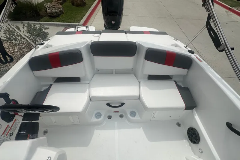 Slide: The Image of 2027 Tahoe T18 boat interior with white and gray seating, red accents, and steering wheel. - 21