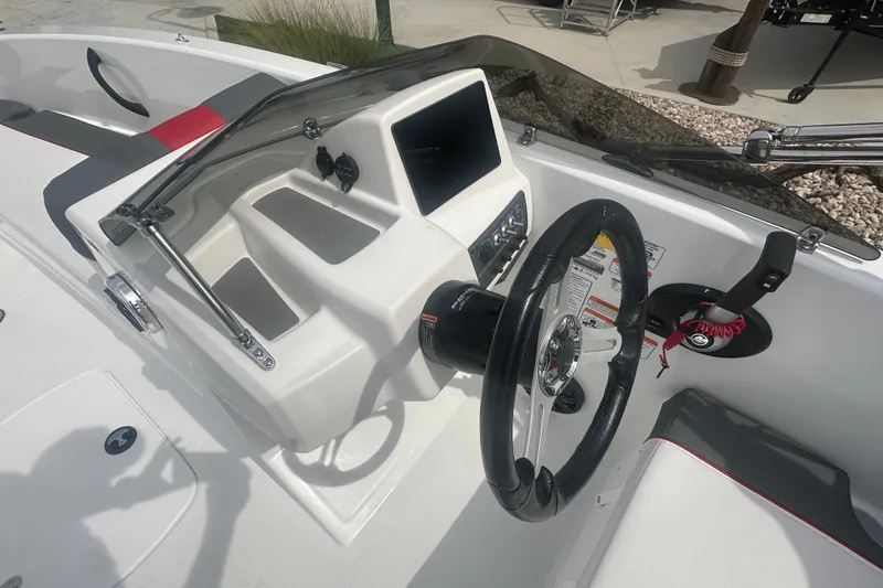 Slide: The Image of 2027 Tahoe T18 boat cockpit with steering wheel, dashboard, and seating. - 17