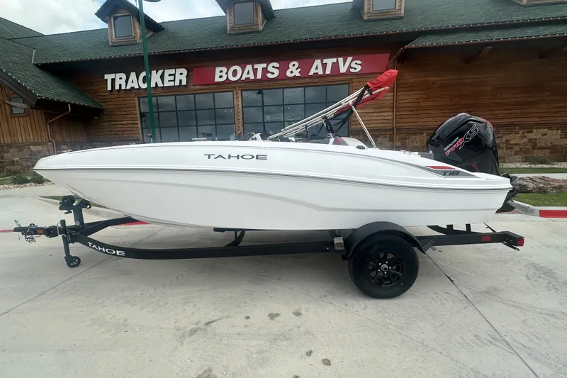 Slide: The Image of 2027 Tahoe T18 boat on trailer outside Tracker Boats & ATVs store. - 2