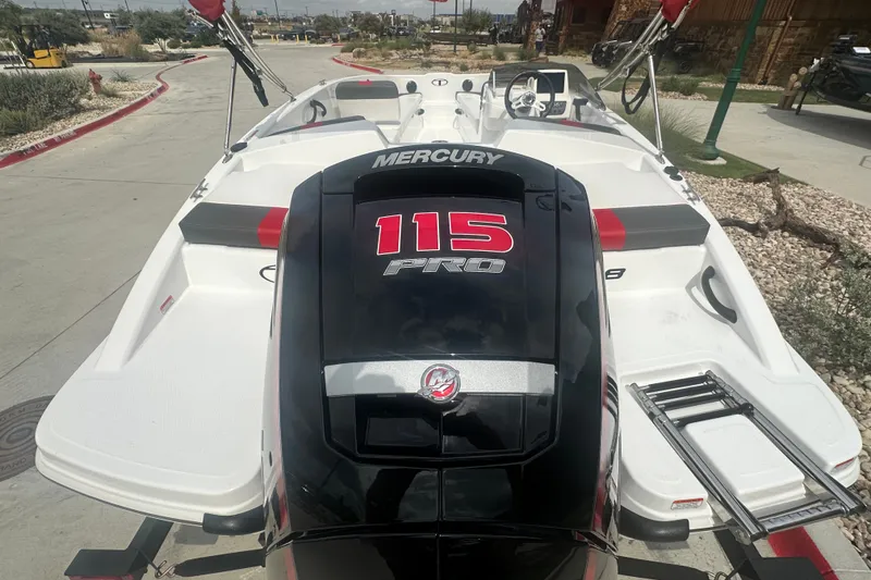 Slide: The Image of 2027 Tahoe T18 boat with Mercury 115 Pro engine, parked outdoors. - 8