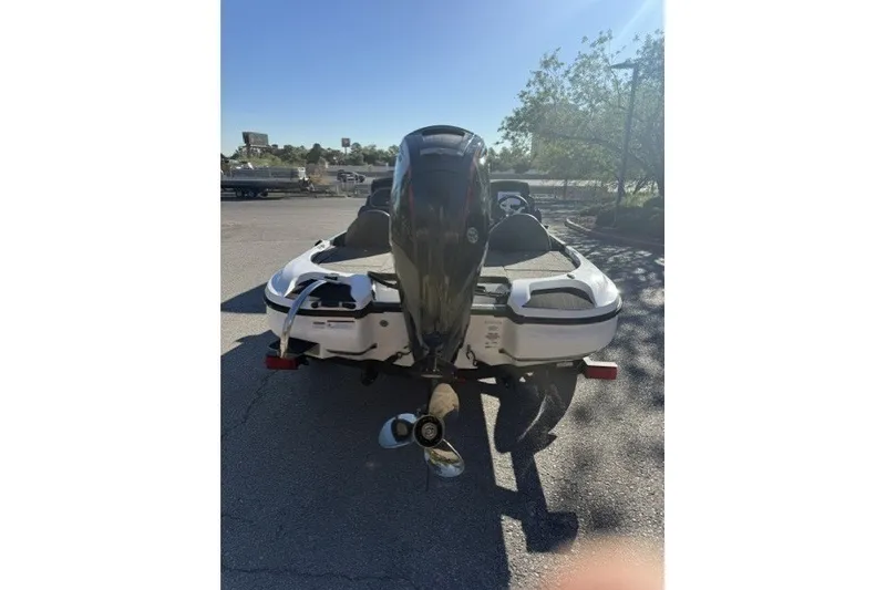 Slide: The Image of Rear view of a 2027 Nitro Z17 boat with an outboard motor in a parking lot. - 3