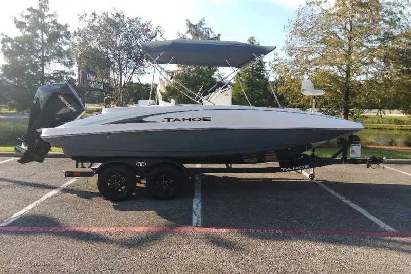 Slide: The Image of 2027 Tahoe 2150 CC boat on trailer in parking lot, side view. - 1