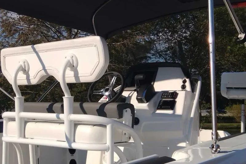 Slide: The Image of 2027 Tahoe 2150 CC boat interior with steering wheel and seating under canopy. - 11
