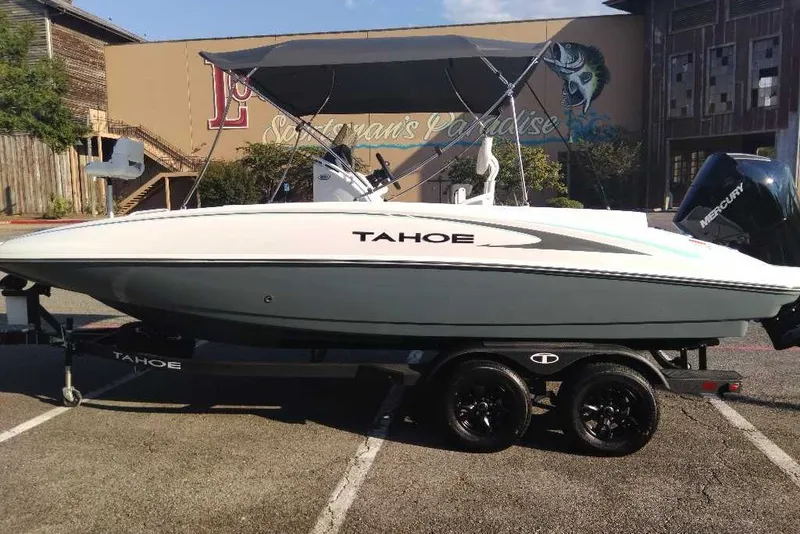 Slide: The Image of 2027 Tahoe 2150 CC boat on trailer, parked outdoors, side view. - 7