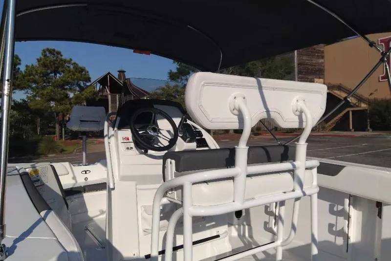 Slide: The Image of 2027 Tahoe 2150 CC boat interior with steering wheel and seating under canopy. - 9