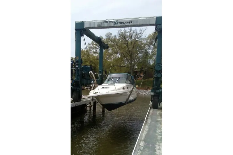 The Image of 1994 Sea Ray 270 Sundancer being lifted by a marine travel lift. - 1