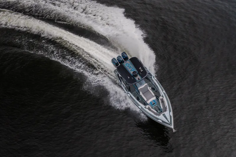 Slide: The Image of Aerial view of 2025 AMP 333 CC speedboat cruising on water, creating dynamic wake. - 10