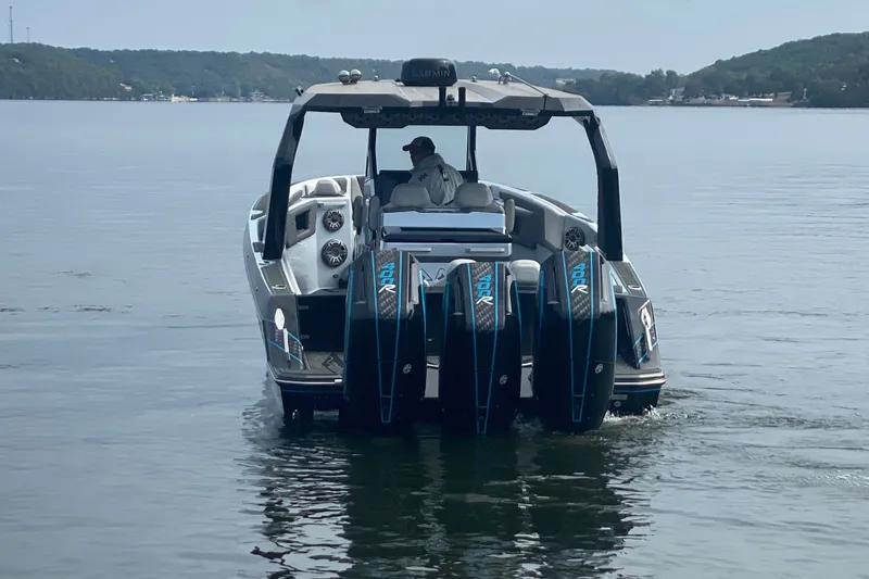 Slide: The Image of 2025 AMP 333 CC boat with multiple engines on a calm lake. - 5