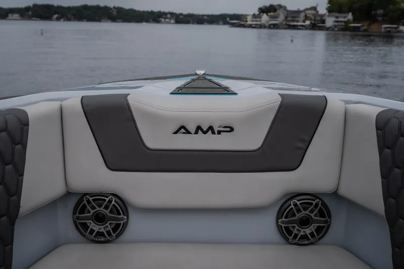 Slide: The Image of Interior view of 2025 AMP 333 CC boat with speakers and logo. - 21