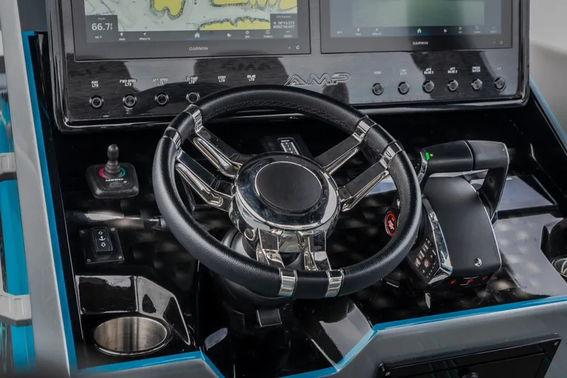 Slide: The Image of Steering console of 2025 AMP 333 CC boat with advanced navigation displays. - 45