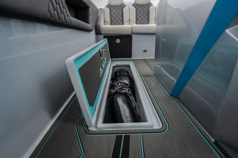 Slide: The Image of 2025 AMP 333 CC boat interior with storage compartment and modern seating design. - 53