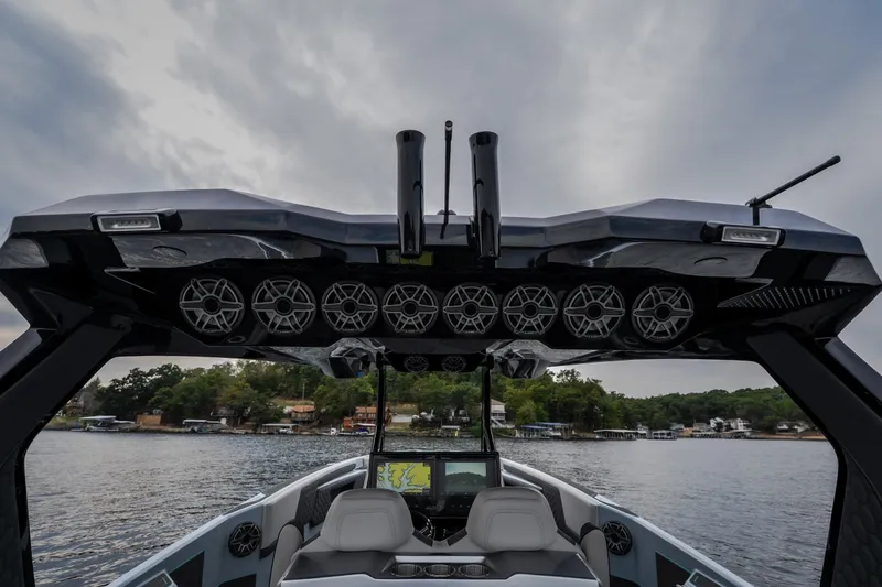 Slide: The Image of Luxury AMP 333 CC boat interior with advanced sound system, 2025 model, on a scenic lake. - 40