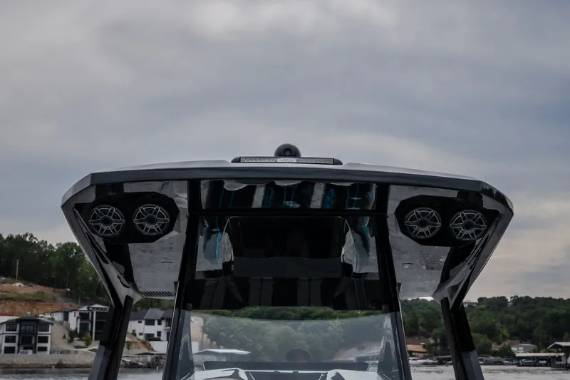 Slide: The Image of 2025 AMP 333 CC boat with sleek design and advanced audio system on a cloudy day. - 28