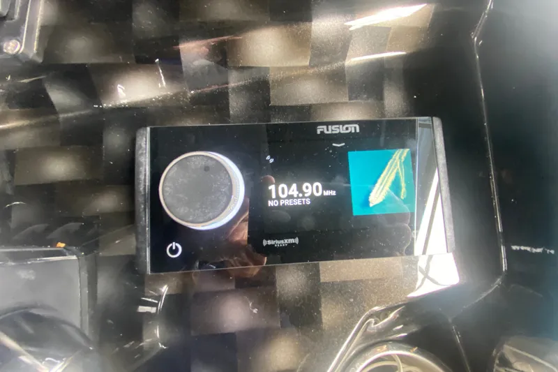 Slide: The Image of AMP 333 CC 2025 model dashboard with Fusion radio display at 104.90 MHz. - 22