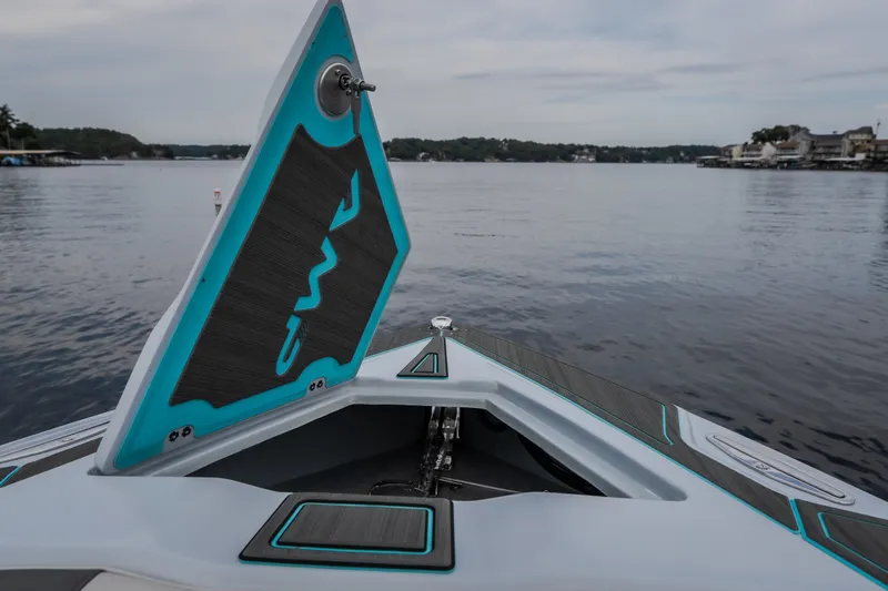 Slide: The Image of Bow of 2025 AMP 333 CC boat on a serene lake, featuring sleek design elements. - 22
