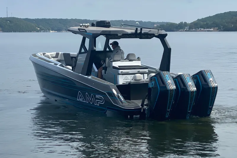 Slide: The Image of 2025 AMP 333 CC boat with triple engines on a calm lake. - 4
