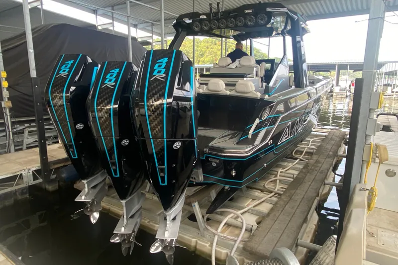 Slide: The Image of 2025 AMP 333 CC boat with triple 400R engines docked in marina. - 8