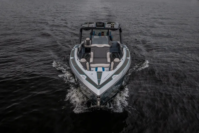 Slide: The Image of 2025 AMP 333 CC boat cruising on open water, showcasing sleek design and luxury seating. - 6