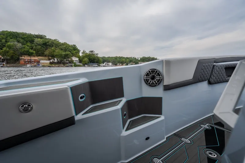 Slide: The Image of Interior view of 2025 AMP 333 CC boat with modern seating and speaker system. - 35