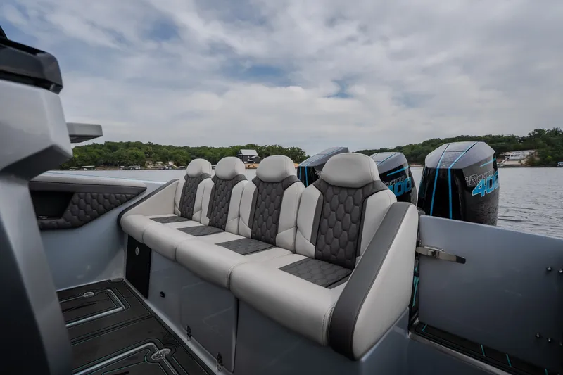 Slide: The Image of Luxury seating on 2025 AMP 333 CC boat with powerful engines, lake view. - 64