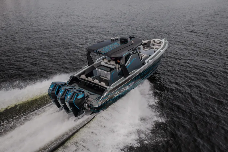 Slide: The Image of 2025 AMP 333 CC boat cruising on open water with powerful engines. - 75