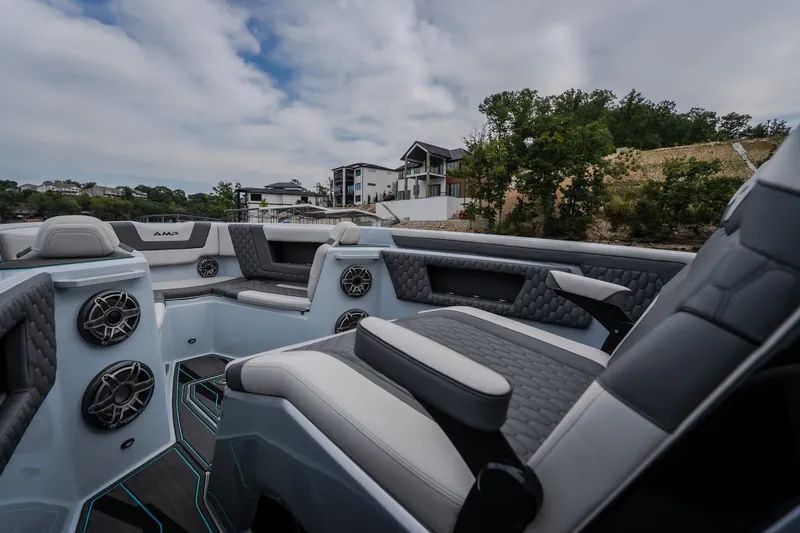 Slide: The Image of Luxurious interior of 2025 AMP 333 CC boat with modern seating and speakers. - 19