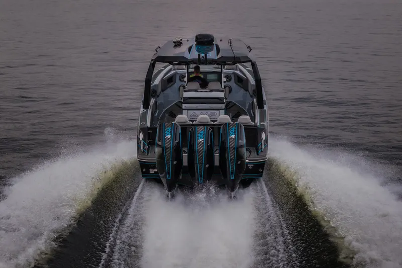 Slide: The Image of 2025 AMP 333 CC boat cruising on water, showcasing powerful engines and sleek design. - 79