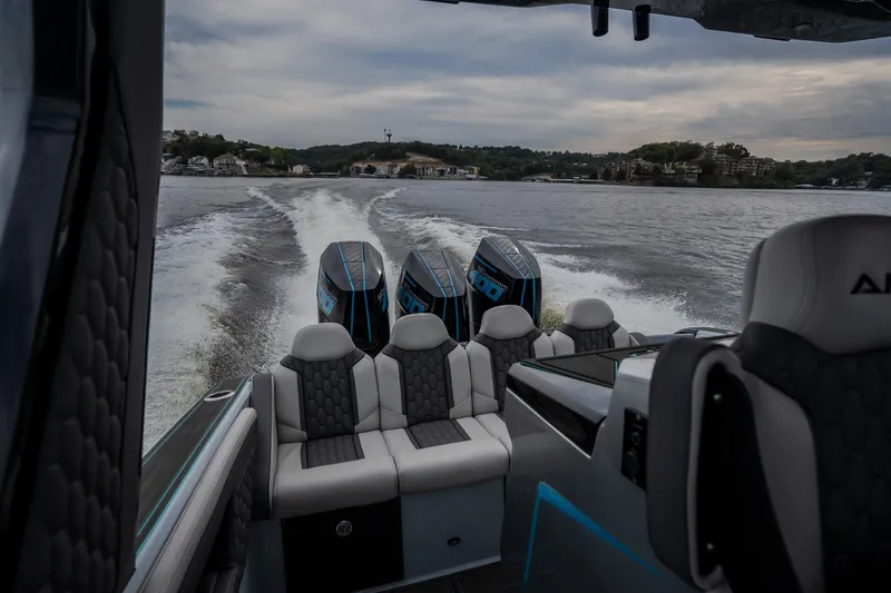 Slide: The Image of 2025 AMP 333 CC boat cruising on a lake with powerful engines. - 34