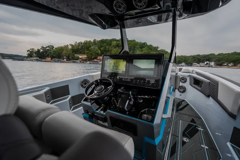 Slide: The Image of Interior view of 2025 AMP 333 CC boat with advanced navigation system and sleek design. - 14