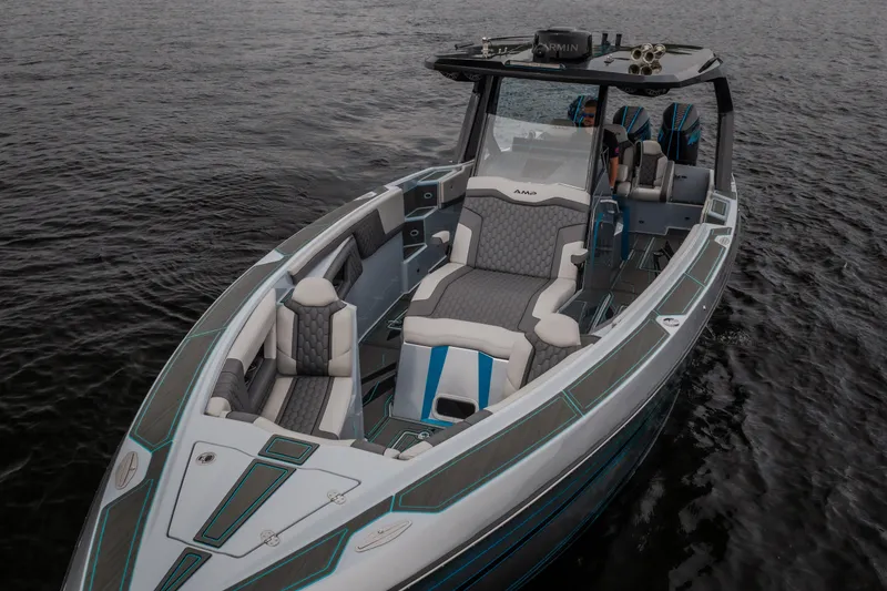 Slide: The Image of 2025 AMP 333 CC boat with sleek design and luxurious seating on calm water. - 68