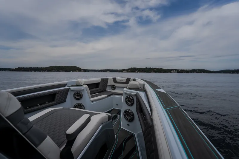 Slide: The Image of Luxury AMP 333 CC boat interior, 2025 model, on calm waters under a cloudy sky. - 30