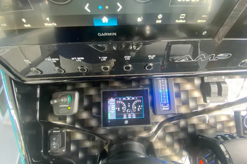 Slide: The Image of Control panel of 2025 AMP 333 CC boat with Garmin display and switches. - 20