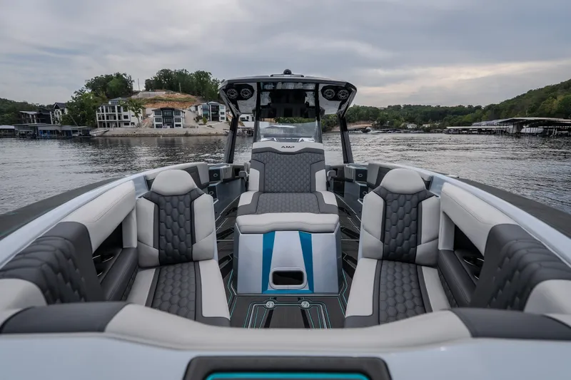 Slide: The Image of Luxurious 2025 AMP 333 CC boat interior with stylish seating on a serene lake. - 24