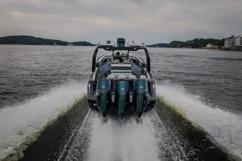 Slide: The Image of 2025 AMP 333 CC boat cruising on a lake, showcasing powerful engines and sleek design. - 7