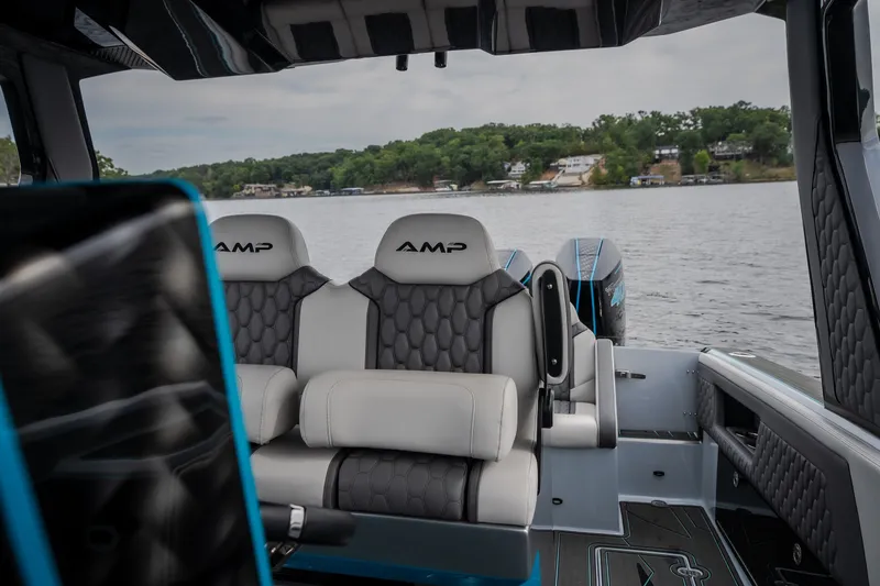 Slide: The Image of Interior of 2025 AMP 333 CC boat with luxurious seating on a lake. - 59