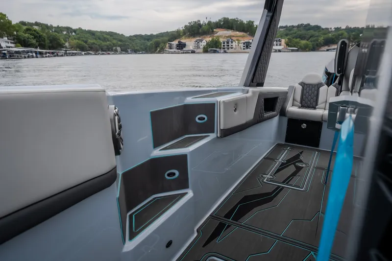 Slide: The Image of Interior of 2025 AMP 333 CC boat with modern seating and sleek design on a lake. - 31