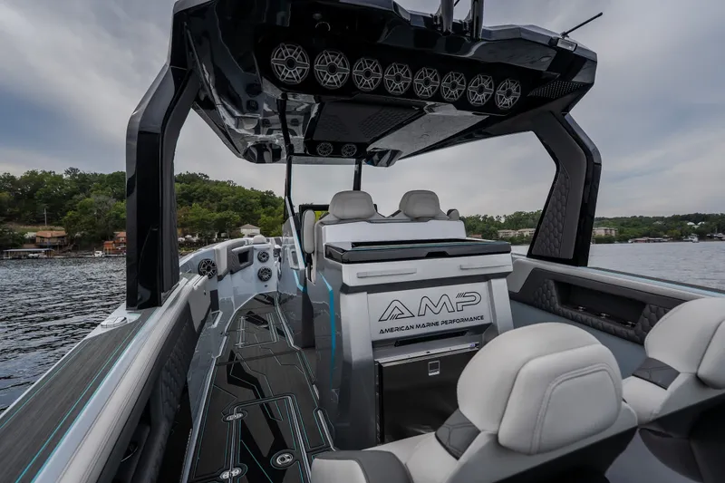 Slide: The Image of Interior of 2025 AMP 333 CC boat with sleek design and advanced features on a lake. - 36