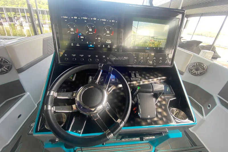 Slide: The Image of Cockpit of 2025 AMP 333 CC boat with advanced navigation display and controls. - 18