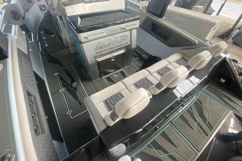 Slide: The Image of 2025 AMP 333 CC boat interior with modern seating and sleek design. - 14