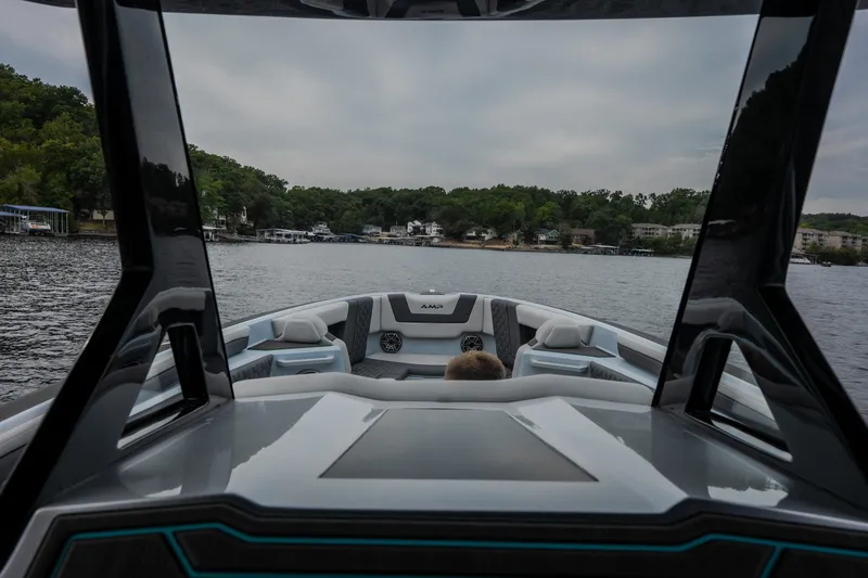 Slide: The Image of Futuristic AMP 333 CC boat interior on a serene lake, 2025 model. - 49