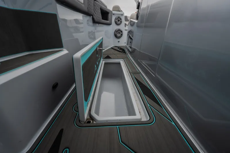 Slide: The Image of Interior view of 2025 AMP 333 CC boat with open storage compartment. - 56