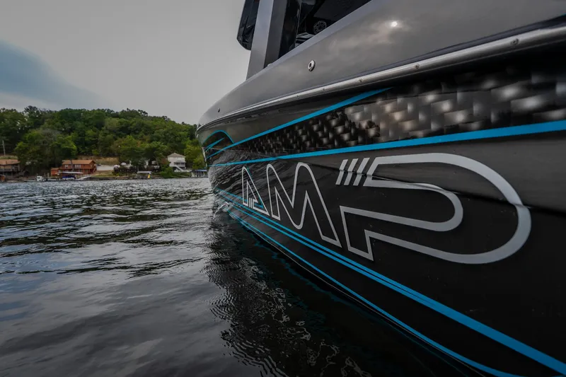 Slide: The Image of 2025 AMP 333 CC boat on water, showcasing sleek design and branding. - 12