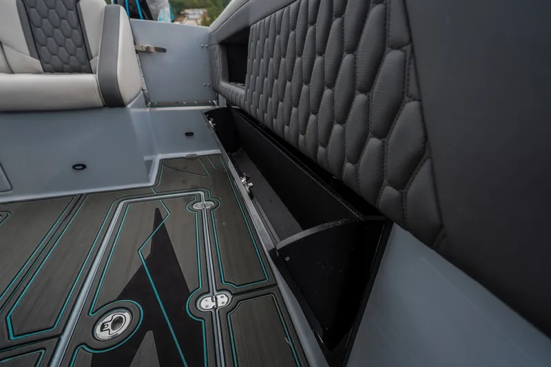 Slide: The Image of Interior of 2025 AMP 333 CC boat with quilted seating and storage compartment. - 55