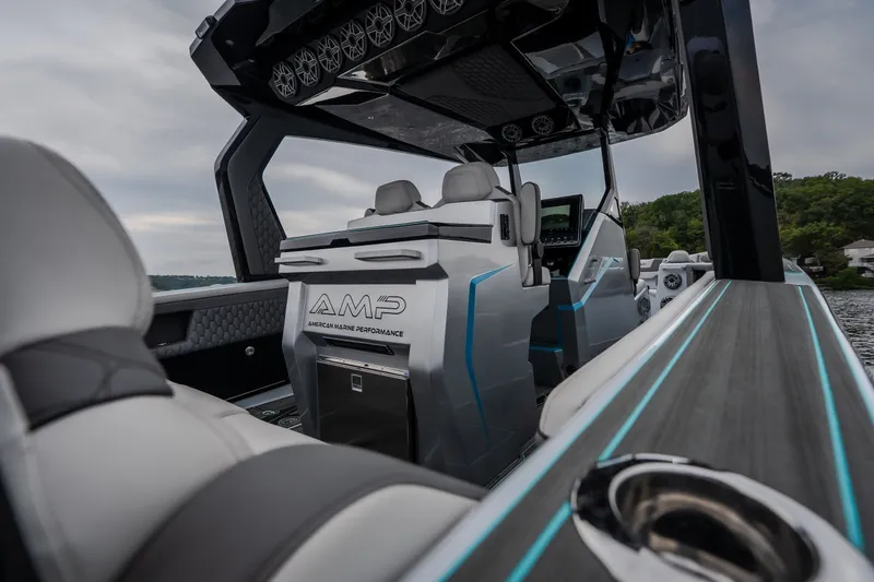 Slide: The Image of Interior of a 2025 AMP 333 CC boat showcasing luxury seating and advanced controls. - 13