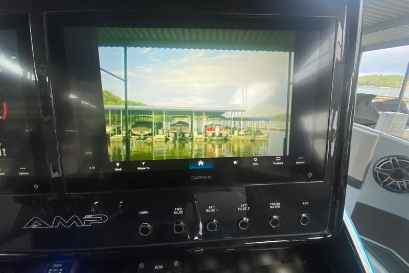 Slide: The Image of Dashboard of 2025 AMP 333 CC boat with Garmin display showing marina view. - 21