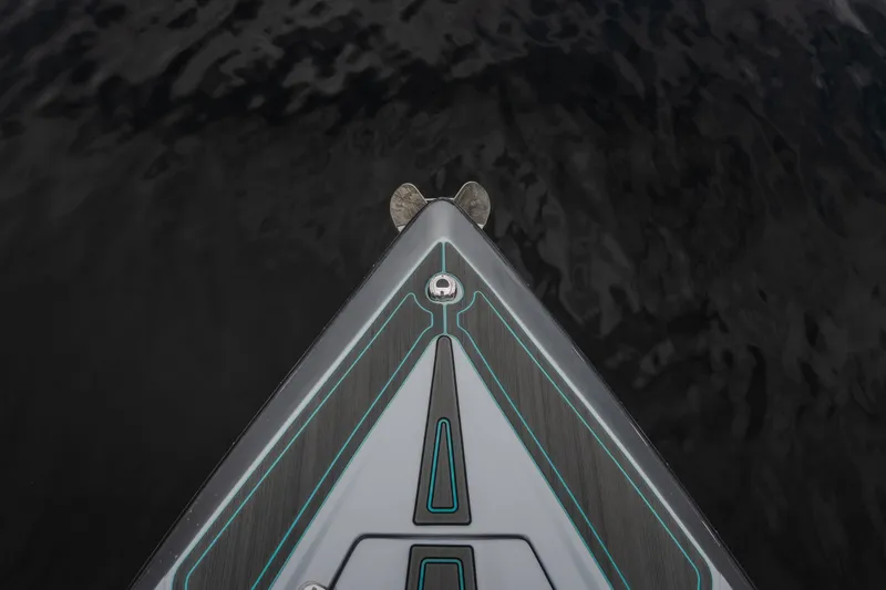 Slide: The Image of Bow of 2025 AMP 333 CC boat with sleek design on dark water. - 11