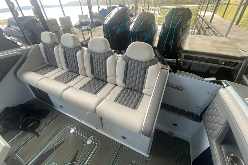 Slide: The Image of Luxurious seating on 2025 AMP 333 CC boat with powerful engines in dock setting. - 15